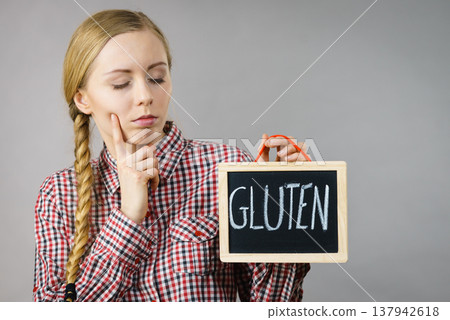 Woman holding board with gluten sign Woman holding board with gluten sign 137942618