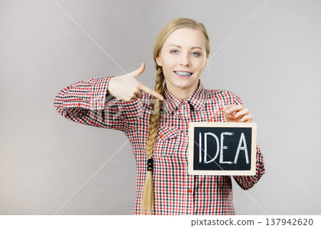 Happy positive woman holding idea sign 137942620