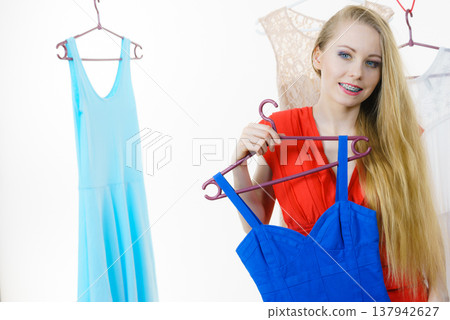 Woman choosing clothes in shop Woman choosing clothes in shop 137942627