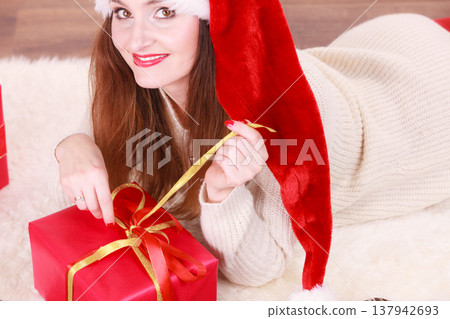 Woman opening gift box. Christmas time Woman opening gift box. Christmas time 137942693