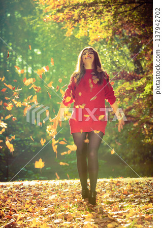 Joyful girl having fun with leaves in autumnal park. Joyful girl having fun with leaves in autumnal park. 137942702