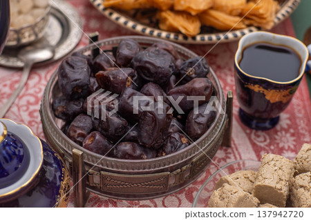 Dried dates. Sweet fruit food. Dessert with coffee cup Dried dates. Sweet fruit food. Dessert with coffee cup 137942720