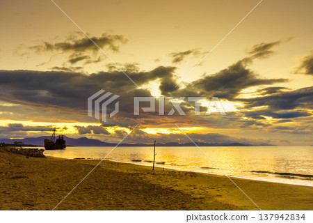 Rusty broken shipwreck on sea shore Rusty broken shipwreck on sea shore 137942834