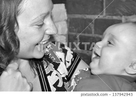 Black and White Close-Up of Mother Smiling at Baby 137942943