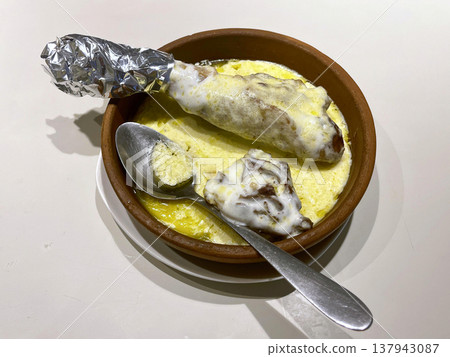 a bowl of food with a spoon and a spoon a bowl of food with a spoon and a spoon 137943087
