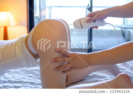 一名女子在伴侶(男友、丈夫)的幫助下,四肢著地使用家用除毛儀進行 VIO 除毛。 一名女子在伴侶(男友、丈夫)的幫助下,四肢著地使用家用除毛儀進行 VIO 除毛。 137943120