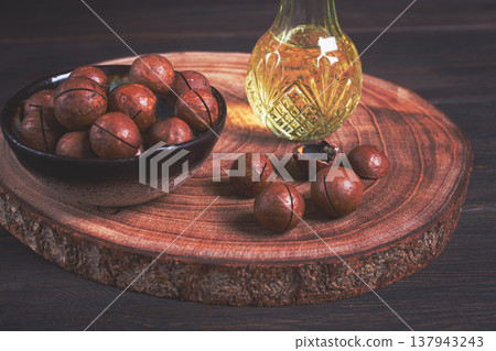 bottle of macadamia oil, on a wooden board, with macadamia nuts, wooden background, selective focus, no people, bottle of macadamia oil, on a wooden board, with macadamia nuts, wooden background, selective focus, no people, 137943243