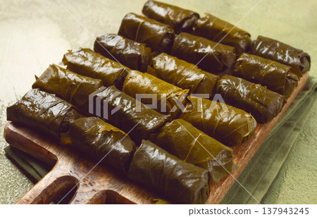 dolma, minced meat with rice, in grape leaves, minced meat rolls, on a chopping board, top view, no people, 137943245
