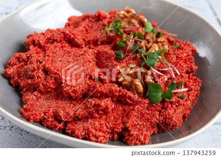 Mahammara red pepper sauce, with walnuts, and sprigs of fresh microgreens, homemade, no people, 137943259