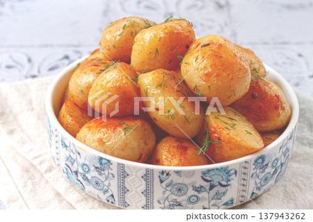 Baked new potatoes, with butter and dill, on a white plate, at home, no people, Baked new potatoes, with butter and dill, on a white plate, at home, no people, 137943262