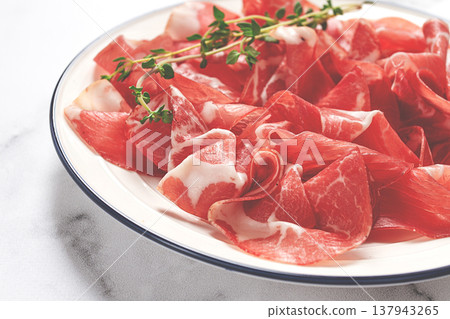 plate with sliced cured meat, pork neck, prosciutto coppa, Italian delicacy, 137943265