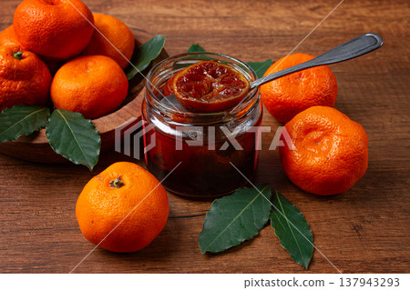 jar of tangerine jam, stands on a wooden table, with fresh tangerines, jar of tangerine jam, stands on a wooden table, with fresh tangerines, 137943293