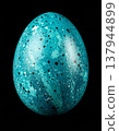 Close Up of Blue Speckled Easter Egg on Black Background 137944899