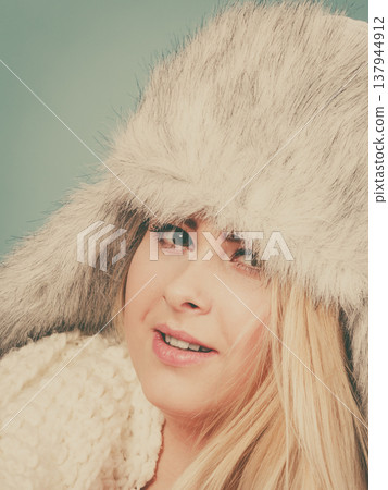 Blonde woman in winter furry hat 137944912