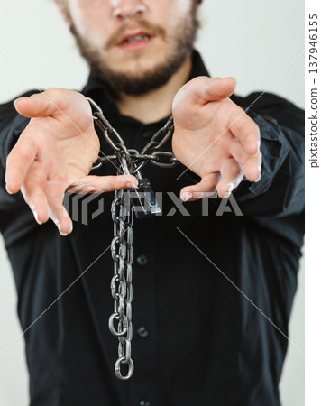 Sad man with chained hands, no freedom 137946155