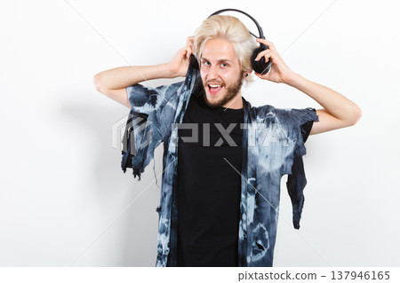 cool guy having fun listens to music in headphones cool guy having fun listens to music in headphones 137946165