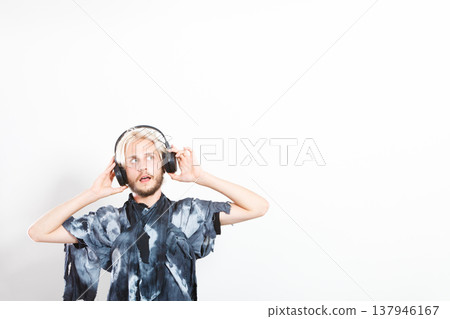 cool guy having fun listens to music in headphones 137946167