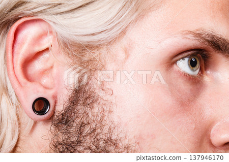 Pierced man ear, black plug tunnel Pierced man ear, black plug tunnel 137946170