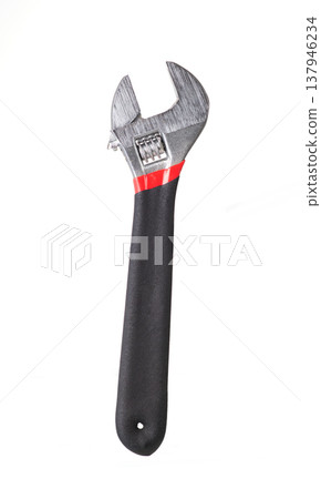 Adjustable wrench with black rubber handle isolated on white background. Metal spanner hand tool for repair Adjustable wrench with black rubber handle isolated on white background. Metal spanner hand tool for repair 137946234