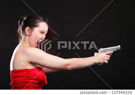 Sexy young woman - gun on black background 137946329