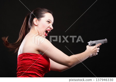 Sexy young woman - gun on black background 137946330