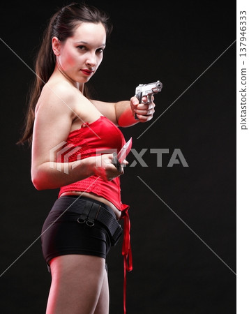 Sexy young woman - gun on black background Sexy young woman - gun on black background 137946333