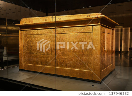 A large, gilded coffin covered in hieroglyphs, part of Tutankhamun's burial artifacts. A large, gilded coffin covered in hieroglyphs, part of Tutankhamun's burial artifacts. 137946382