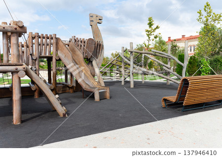 A playground with a slide and a bench 137946410