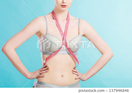 Woman in underwear with measure tape Woman in underwear with measure tape 137946846