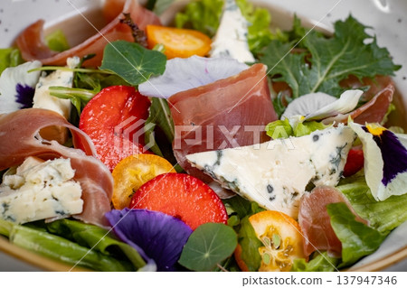 Salad mix with jamon, baby mozzarella, strawberries and vinaigrette sauce. Salad mix with jamon, baby mozzarella, strawberries and vinaigrette sauce. 137947346
