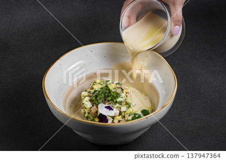Cold summer soup okroshka. Light soup in a white bowl. Cold summer soup okroshka. Light soup in a white bowl. 137947364