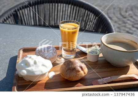 Flemish indulgent coffee set on sunny terrace Flemish indulgent coffee set on sunny terrace 137947436