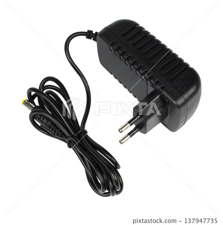laptop power adapter, laptop spare part, on a white background, angled side view laptop power adapter, laptop spare part, on a white background, angled side view 137947735