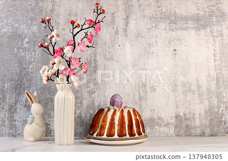 Traditional Easter cake, Easter bunny figurines and cherry blossom branches in a vase on an elegant kitchen background, Easter celebration concept, Easter dish ideas for home cooking, design template 137948305