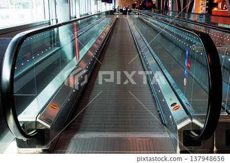 Wide angle view of an empty moving walkway in an international airport. Travelator with perspective lines 137948656