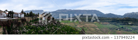 Panoramic view of surrounding landscapes and mountains from scenic elevated viewpoint in Ronda, Spain. 137949224