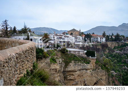 Panoramic view of surrounding landscapes and mountains from scenic elevated viewpoint in Ronda, Spain. 137949233