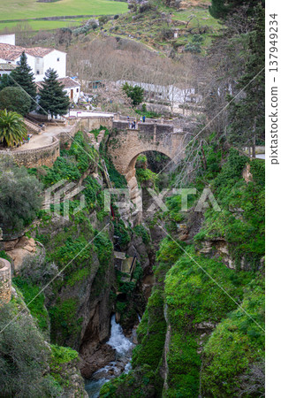 Panoramic view of surrounding landscapes and mountains from scenic elevated viewpoint in Ronda, Spain. Panoramic view of surrounding landscapes and mountains from scenic elevated viewpoint in Ronda, Spain. 137949234