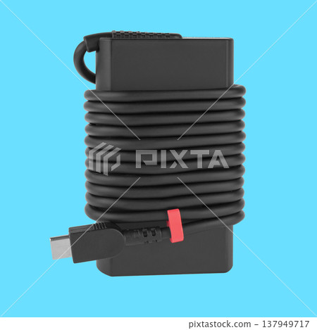 laptop power adapter, laptop accessory, on a blue background laptop power adapter, laptop accessory, on a blue background 137949717