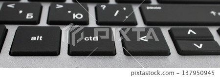 Part of the keyboard from the laptop buttons close-up angle view 137950945