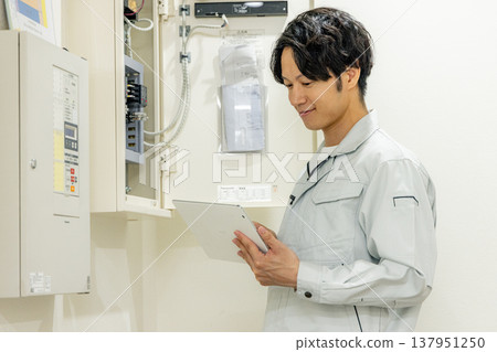 Man inspecting breaker Man inspecting breaker 137951250