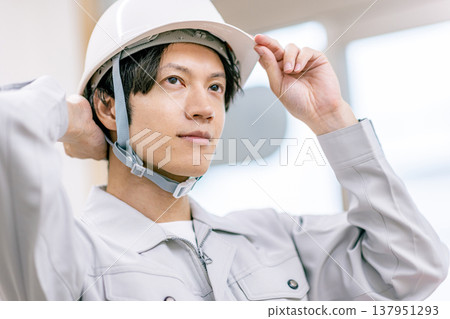 A man wearing a helmet A man wearing a helmet 137951293