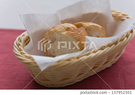 Baguette bread basket served in a French restaurant Baguette bread basket served in a French restaurant 137952301