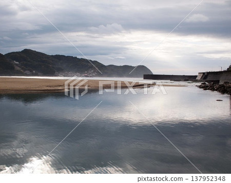 A sandy beach in the morning after the rain. A sandy beach in the morning after the rain. 137952348
