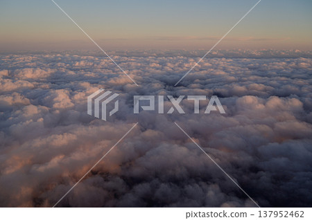 Clouds bathed in the sunset, as seen from above: a skyscape. Clouds bathed in the sunset, as seen from above: a skyscape. 137952462