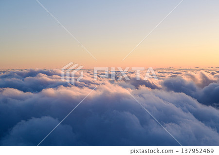 Clouds bathed in the sunset, as seen from above: a skyscape. Clouds bathed in the sunset, as seen from above: a skyscape. 137952469