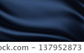 Luxury dark blue fabric background with smooth flowing waves and copy space 3D render 137952873