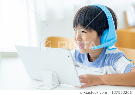 Boy studying on a tablet 137953266