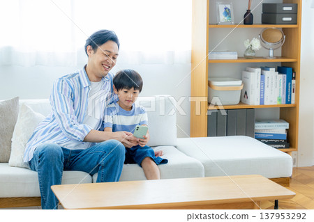 Young family looking at a smartphone Young family looking at a smartphone 137953292