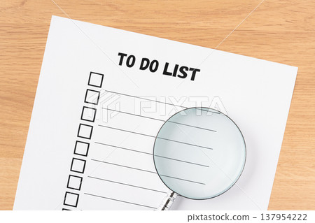 To-do list paper and magnifying glass 137954222